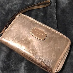 Used Michael Kors metallic ROSE GOLD wristlet